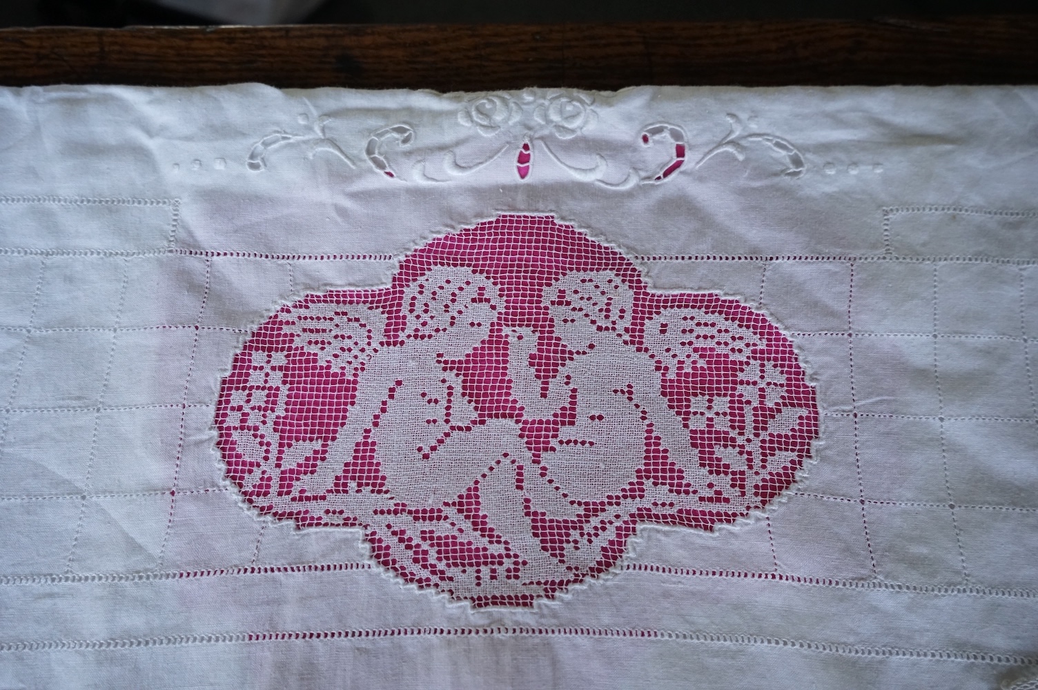 A late 19th century early 20th century finely woven, hand worked linen sheet 6’8”wide, together with a near matching large square pillowcase. Both items worked in Embroidery Anglaise, button holed and inset and trimmed w
